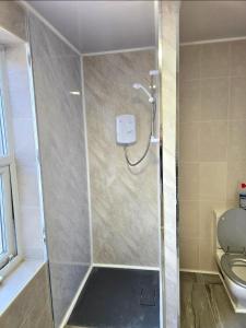 a shower in a bathroom with a toilet at Red Lions Liverpool in Liverpool