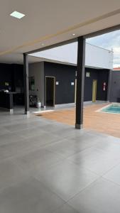 a large empty building with a pool in the middle at Casa para lazer e confraternização in Senador Canedo
