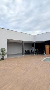 a large white building with a large patio at Casa para lazer e confraternização in Senador Canedo