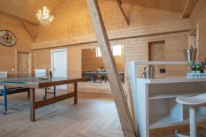 a room with wooden walls and a table and chairs at Hof Friesenruhe in Högel +68 photos