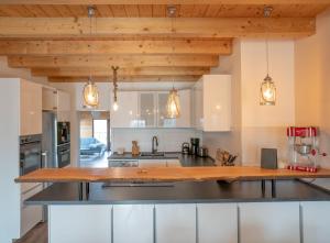 a kitchen with white cabinets and a wooden counter top at Hof Friesenruhe in Högel