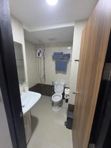 a small bathroom with a toilet and a sink at Mai Khao 777 Beach Condo in Ban Mai Salae +10 photos