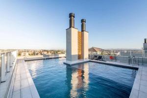 a swimming pool on the roof of a building at Loft Exclusivo - Maxplaza in Canoas