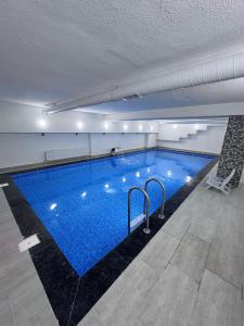a large swimming pool in a building at The Montana City Hotel in Bostaniçi
