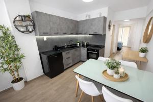 a kitchen with a white table and a dining room at Opal Apartments Luxury by the Sea in Hersonissos +38 photos