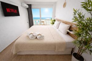 a bedroom with a bed with two towels on it at Opal Apartments Luxury by the Sea in Hersonissos