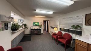 a waiting room in a hospital with red chairs at clarion hometown inn in Clarion