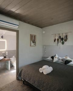 a bedroom with a bed with towels on it at Green Sanctuary Hotel in Nosara