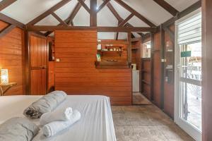 a bedroom with a bed with two pillows on it at Les Cottages Couleur Café in Cul de Sac
