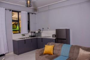 a living room with a couch and a kitchen at The Views Apartments in Kariba