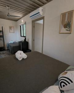 a bedroom with two beds with towels on them at Green Sanctuary Hotel in Nosara