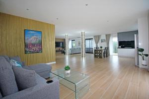 a living room with a couch and a table at Your Private Escape with city views in Auckland