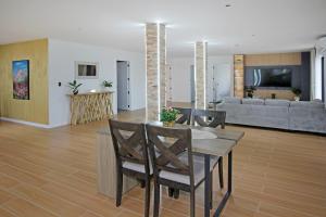 a living room with a table and chairs and a couch at Your Private Escape with city views in Auckland +16 photos