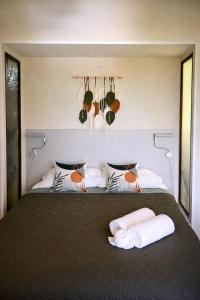 a bedroom with a bed with two towels on it at Green Sanctuary Hotel in Nosara +44 photos