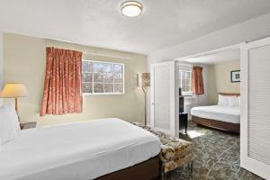 a hotel room with two beds and a window at Rose Garden Inn - San Jose Airport in San Jose