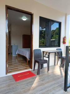a room with a table and chairs and a window at Simon Guest House in San Juan