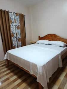 a bedroom with a large white bed in a room at Simon Guest House in San Juan