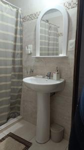 a bathroom with a sink and a mirror at Rincón del Hum in Mercedes