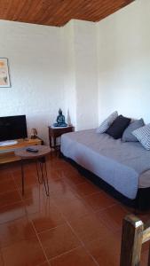 a bedroom with a bed and a desk with a computer at Rincón del Hum in Mercedes