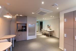 an office with tables and chairs and a kitchen at OstelloMaree 오스텔로마레 Tax Benefit in Seoul