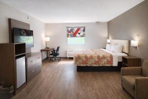 a hotel room with a bed and a television at Motel 6 Lake City, FL – Medical Center in Lake City