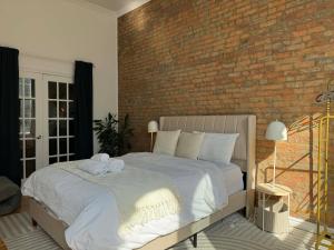 a bedroom with a bed with a brick wall at Top Location - The 777 Old Port Gem in Montreal