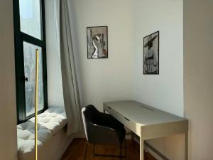 a desk and a chair in a room with a window at Top Location - The 777 Old Port Gem in Montreal +30 photos