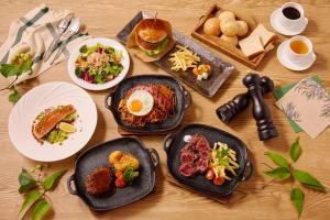 a wooden table with plates of food on it at Villa Fontaine Grand Tokyo Shiodome in Tokyo