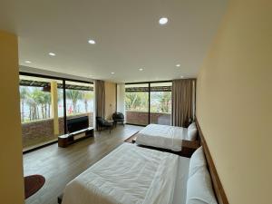 a bedroom with two beds and a large window at Con Nho RiverHouse Hue in Thôn Tiên Nộn +233 photos