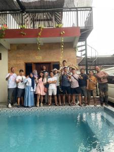 a group of people standing next to a swimming pool at Indah Nusantara in Banyuwangi
