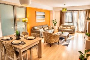 a living room with a table and a couch at Capitоl Suites & Apartments in Skopje +30 photos