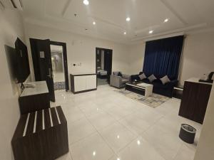 a large living room with a couch and a table at Golden Bujari Bisha in Qal'at Bishah