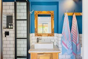 a bathroom with a sink and a mirror at The Warren @White.Rabbit.House in Plettenberg Bay