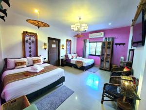 a bedroom with two beds and a couch in it at Arawan Pool Villa Hua Hin in Hua Hin