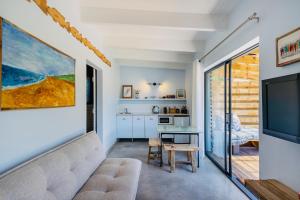 a living room with a couch and a tv at The Warren @White.Rabbit.House in Plettenberg Bay +12 photos