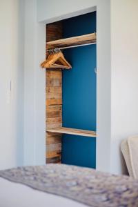 a room with a bed and wooden shelves at The Warren @White.Rabbit.House in Plettenberg Bay