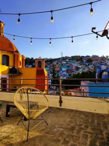 a yellow chair sitting on top of a roof at Balcones de Galarza 24 in Guanajuato