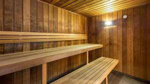 a wooden sauna with a wooden bench in it at Stylish Beachside Retreat in Gold Coast