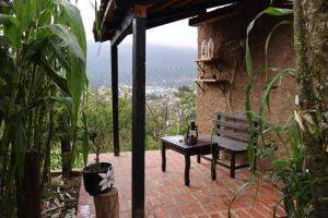 a bench sitting on a patio with a view at Villa Xanvil in Zinacantán