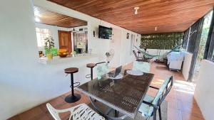 a dining room with a table and chairs and a hammock at Casa Pochote, Cobano in Cóbano