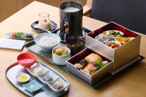 a table with a tray of food on a table at THE THOUSAND KYOTO in Kyoto