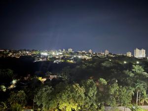 a view of a city at night at Vertice House - Copacabana in Uberlândia
