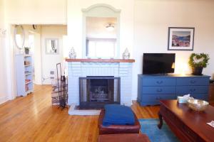 a living room with a fireplace and a tv at Downtown Apt #6 Amazing View - 23 Queen's Rd in St. John's