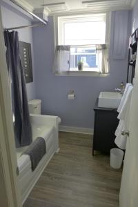 a bathroom with a tub and a sink and a window at Downtown Apt #6 Amazing View - 23 Queen's Rd in St. John's +25 photos