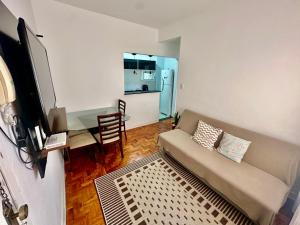 a living room with a couch and a table at Apartamento Premium Liberdade in São Paulo
