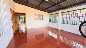 an empty hallway of a house with a bike parked in it at Casa Pochote, Cobano in Cóbano