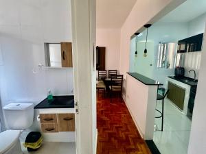 a kitchen with a sink and a toilet in a room at Apartamento Premium Liberdade in São Paulo +9 photos