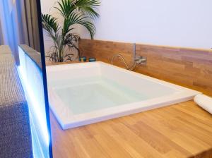 a bath tub sitting on top of a wooden floor at Cala Bianca in Trani