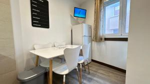 a kitchen with a table and chairs and a refrigerator at Sky 401 by CONFORTSKY in Pas de la Casa