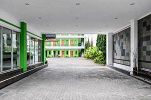 an empty hallway of a building with green accents at RedDoorz Plus near The Great Asia Africa Lembang in Bandung
